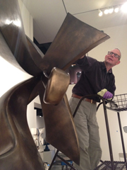 Tom Fuller conserving Manuel Izquierdo's sculpture Constellation at the Hallie Ford Museum of Art.